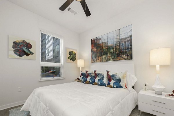 Stylish bedroom with modern decor and ample natural light at 30Six NoDa Apartments