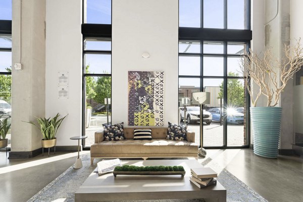 Lively lobby with modern seating and vibrant artwork in 30Six NoDa Apartments, showcasing a welcoming community space