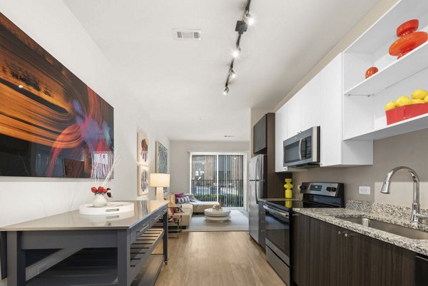 Contemporary kitchen with sleek fixtures and stainless steel appliances at 30Six NoDa Apartments