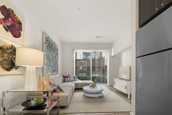 Living room with contemporary decor and large windows at 30Six NoDa luxury apartments