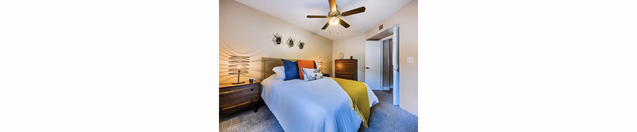 Modern bedroom with elegant decor and large windows at Avana at the Pointe Apartments