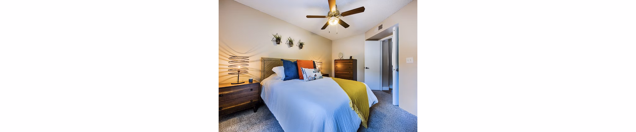 Modern bedroom with elegant decor and large windows at Avana at the Pointe Apartments