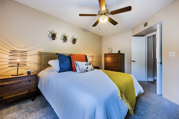 Modern bedroom with elegant decor and large windows at Avana at the Pointe Apartments