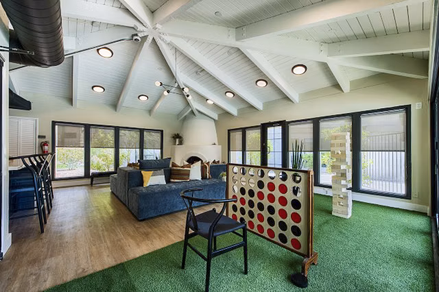 Vibrant game room with pool table and seating area at Avana at the Pointe Apartments