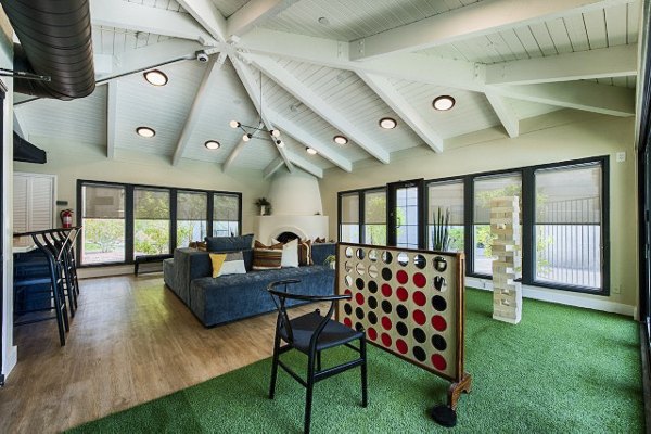 Vibrant game room with pool table and seating area at Avana at the Pointe Apartments