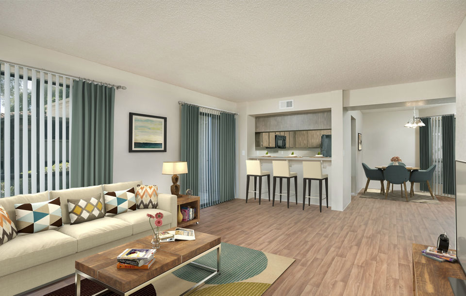 Spacious living room with modern decor at Avana at the Pointe Apartments, featuring cozy seating and large windows