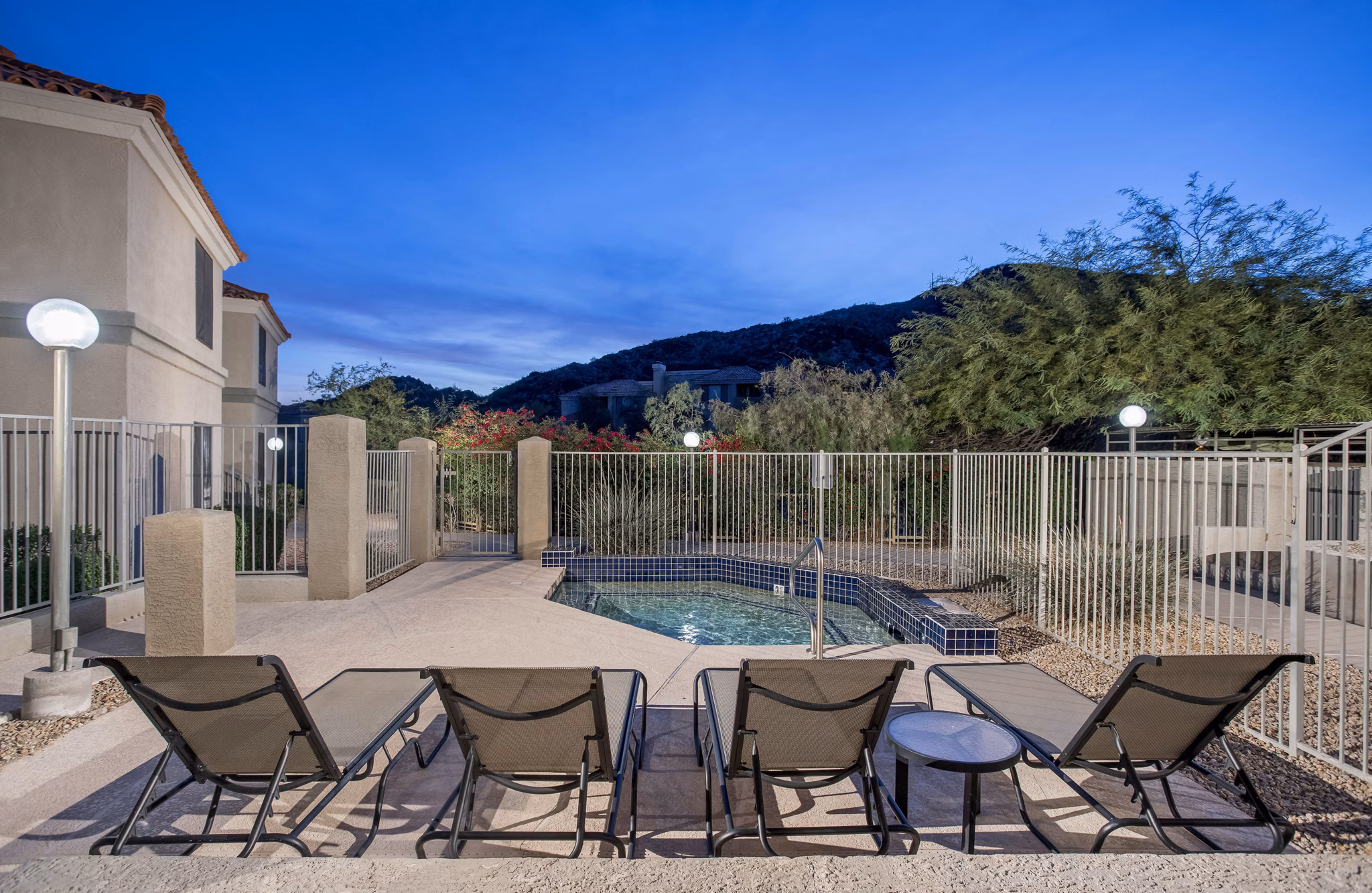 Resort-style pool with vibrant landscaping at Avana at the Pointe Apartments, enhancing luxury outdoor living experience