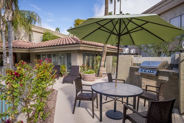 Outdoor grill area with modern seating at Avana at the Pointe Apartments, perfect for social gatherings and BBQs