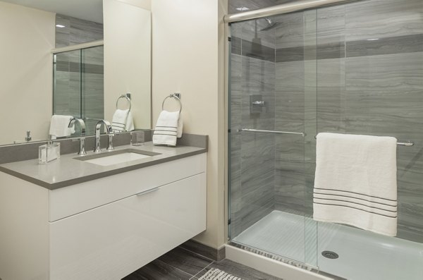 Bathroom with modern fixtures and marble countertops at Atlantic Station Apartments luxury residences
