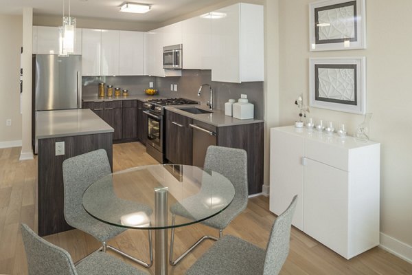 Atlantic Station Apartments: Modern dining room with sleek furniture and stylish lighting fixtures in luxury setting