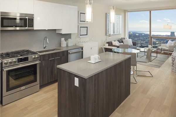 Modern kitchen with stainless steel appliances and granite countertops at Atlantic Station Apartments