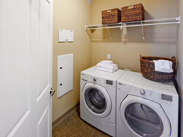 Modern laundry room with state-of-the-art appliances in Jory Trail Apartments, offering convenience and style for residents