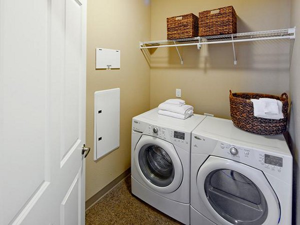 Modern laundry room with state-of-the-art appliances in Jory Trail Apartments, offering convenience and style for residents