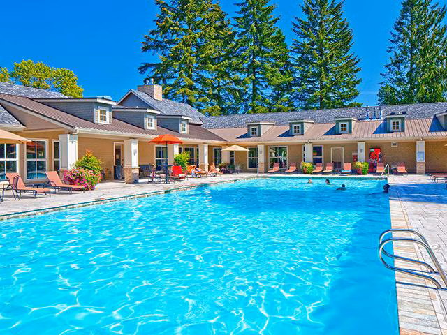 Resort-style pool with lounge chairs at Jory Trail Apartments
