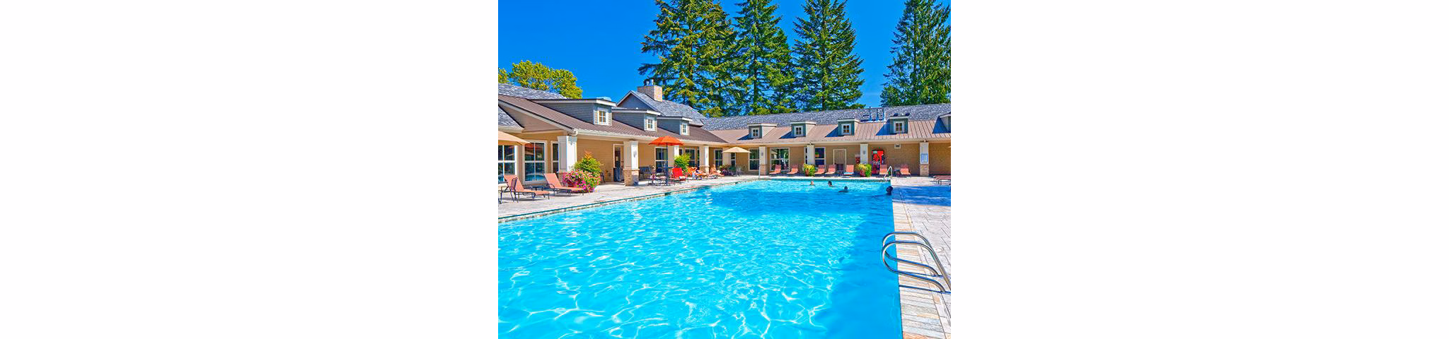 Resort-style pool with lounge chairs at Jory Trail Apartments