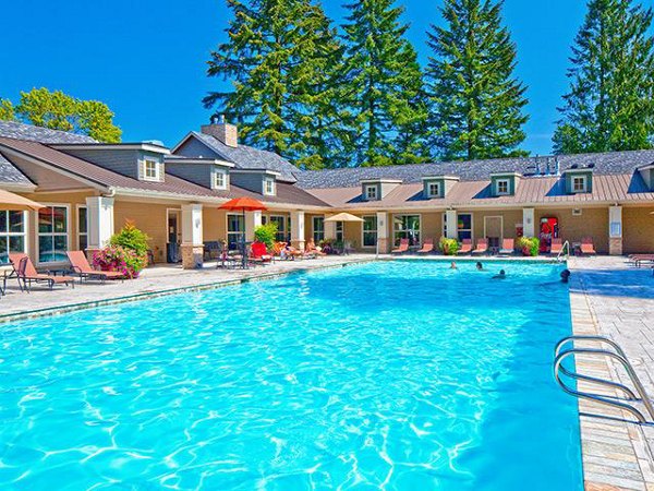 Resort-style pool with lounge chairs at Jory Trail Apartments