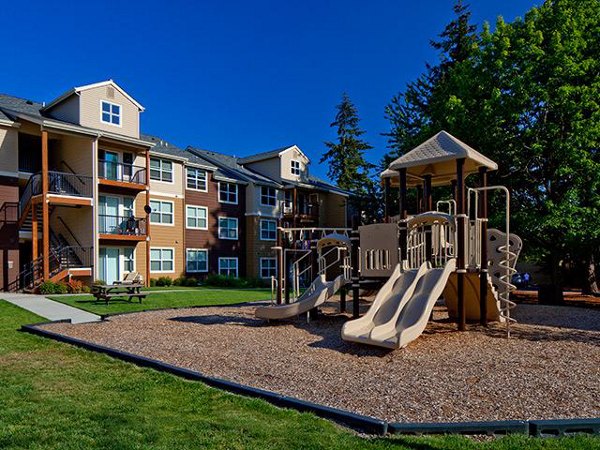 Colorful playground with modern equipment at Jory Trail Apartments, providing family-friendly outdoor fun for residents