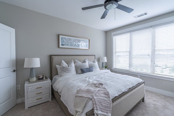 Cozy bedroom with elegant furnishings at The Sawyer Providence Farm Apartments