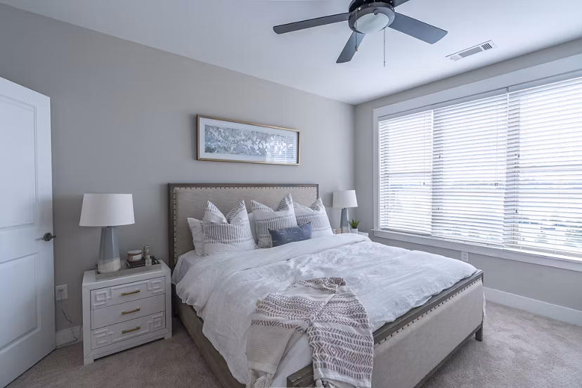 Cozy bedroom with stylish design at The Sawyer Providence Farm Apartments, featuring modern decor and ample natural light