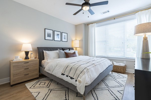 Cozy bedroom with stylish design at The Sawyer Providence Farm Apartments, featuring modern decor and ample natural light