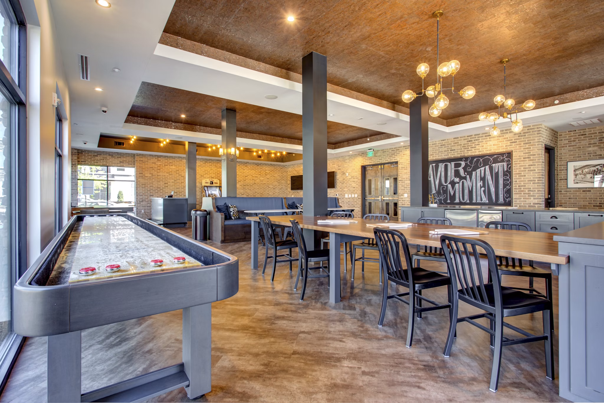 Clubhouse with modern decor and expansive seating at The Sawyer Providence Farm Apartments, offering luxury living spaces for residents