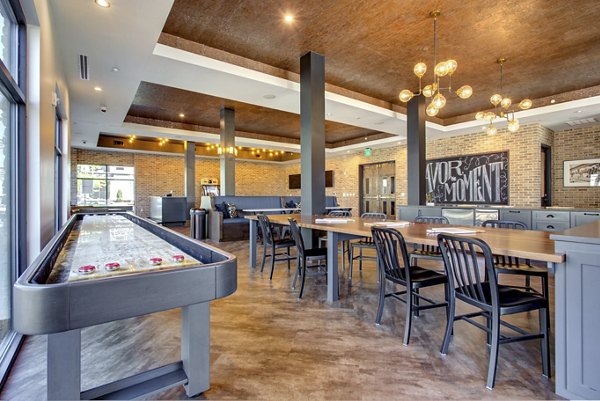 Clubhouse with modern decor and expansive seating at The Sawyer Providence Farm Apartments, offering luxury living spaces for residents