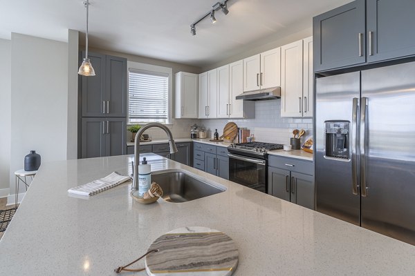 Modern kitchen with stainless steel appliances at The Sawyer Providence Farm Apartments, ideal for luxury living in a Greystar community