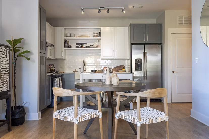 Contemporary kitchen with stainless steel appliances and granite countertops at The Sawyer Providence Farm Apartments