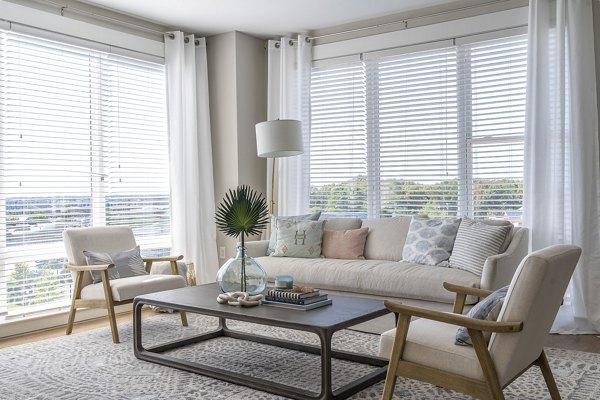 Modern living room with natural light at The Sawyer Providence Farm Apartments