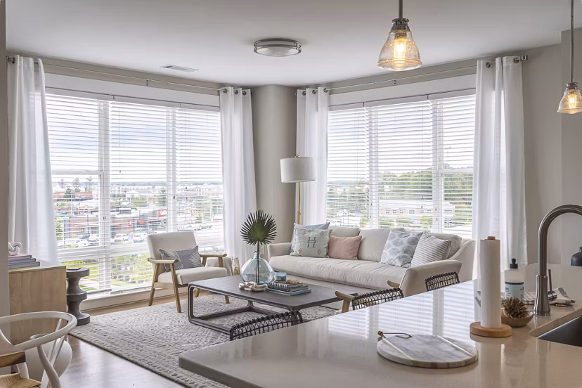 Living room with modern decor and natural light at The Sawyer Providence Farm Apartments