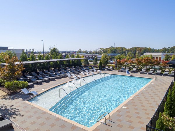 Sparkling pool at The Sawyer Providence Farm Apartments with sun deck and loungers, a luxury community by Greystar