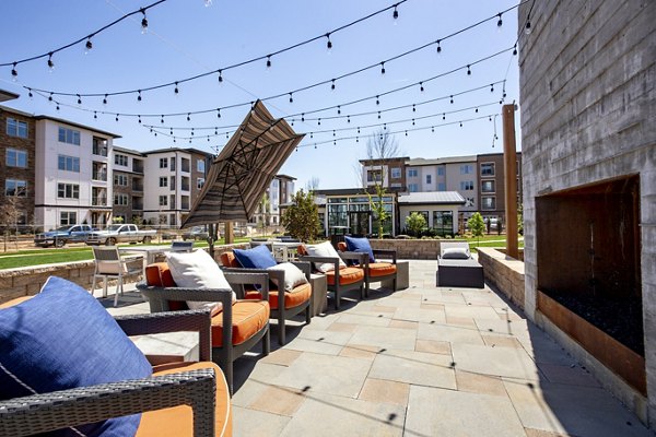 Courtyard with lush landscaping and seating areas at The Sawyer Providence Farm Apartments