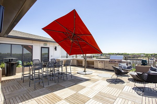 Outdoor grill area with modern seating at The Sawyer Providence Farm Apartments