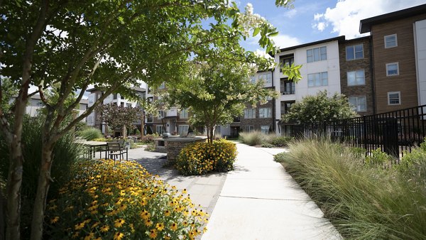 Courtyard with lush greenery at The Sawyer Providence Farm Apartments, encapsulating luxury living and modern design