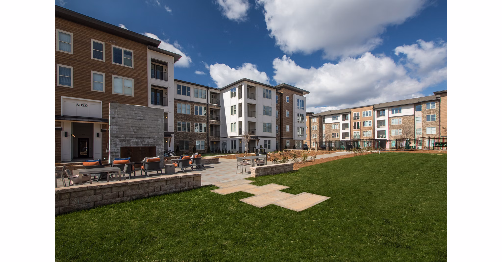 Charming courtyard with lush greenery at The Sawyer Providence Farm Apartments