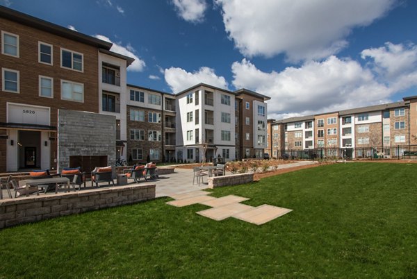 Charming courtyard with lush greenery at The Sawyer Providence Farm Apartments