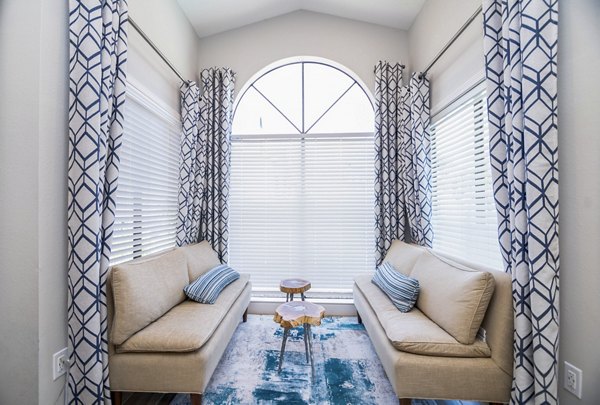 Clubhouse featuring elegant interiors and seating areas at Green Tree Place Apartments in a serene setting