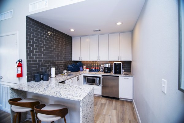 Modern kitchen with stainless steel appliances in the clubhouse at Green Tree Place Apartments