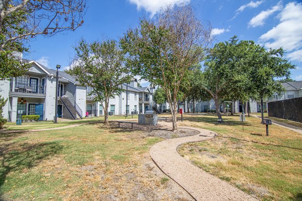 Outdoor grill area with modern patio furniture at Green Tree Place Apartments, ideal for social gatherings and relaxation in a luxury setting