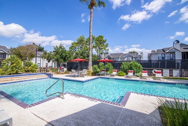 Outdoor pool area with lounge seating at Green Tree Place Apartments