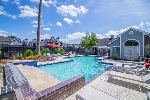 Luxurious pool area with deck chairs at Green Tree Place Apartments, perfect for relaxation and socializing outdoors