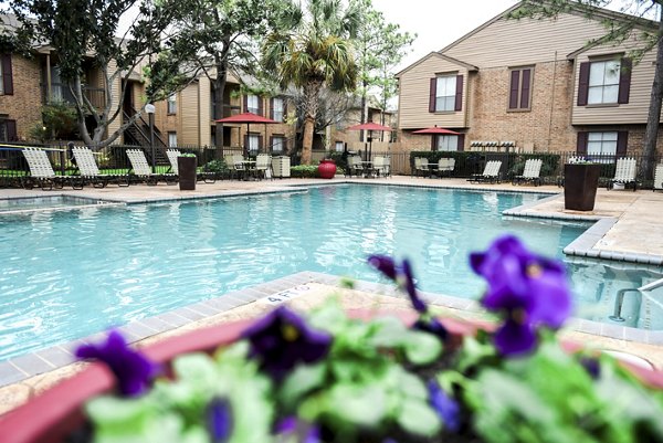 Elegant poolside retreat at Westborough Crossing Apartments with luxury seating and lush landscaping