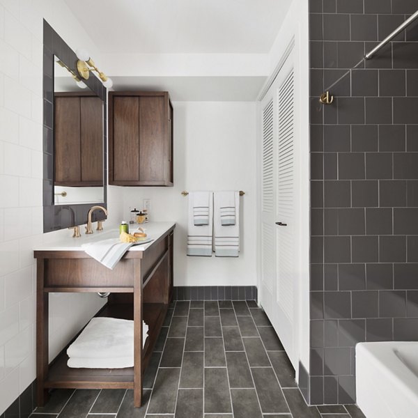 The Ludlow Apartments: Modern bathroom with sleek fixtures and neutral tones