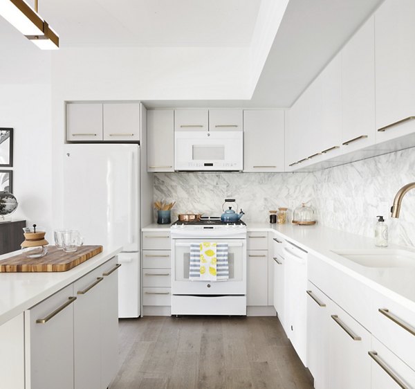 Modern kitchen featuring sleek countertops and stainless steel appliances at The Ludlow Apartments