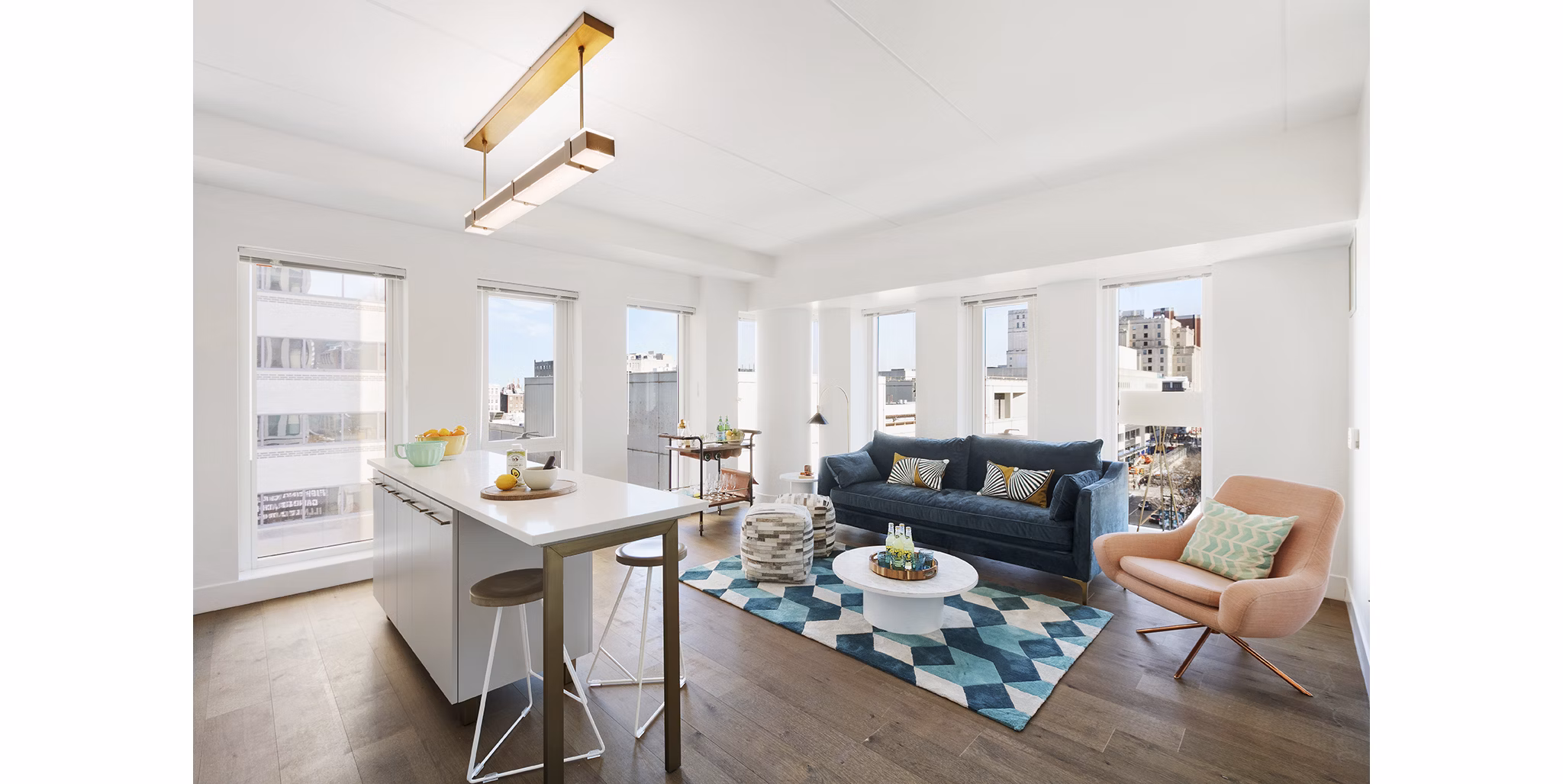 Living room with modern dÃ©cor and large windows at The Ludlow Apartments, luxury living in New York City