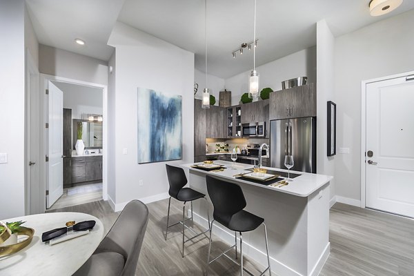 Modern kitchen with stainless steel appliances and granite countertops at Overture Kierland apartments