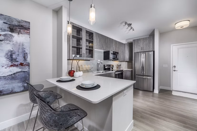 Modern kitchen with granite countertops and stainless steel appliances at Overture Kierland luxury apartments