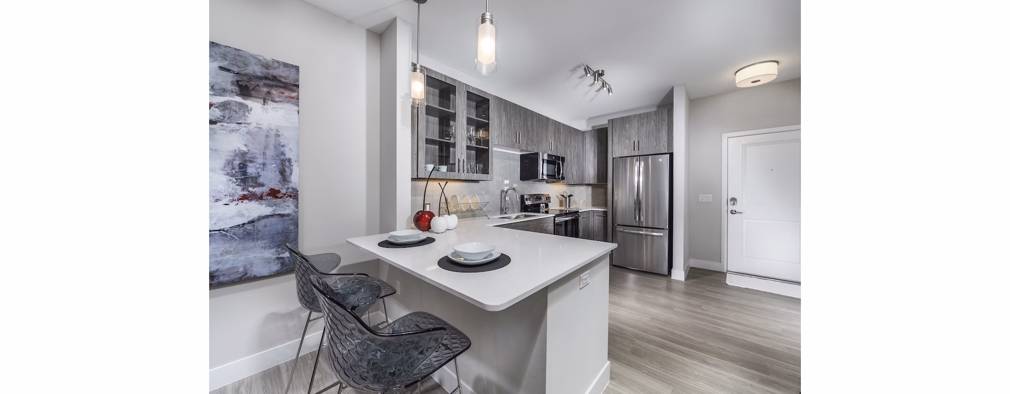 Modern kitchen with granite countertops and stainless steel appliances at Overture Kierland luxury apartments