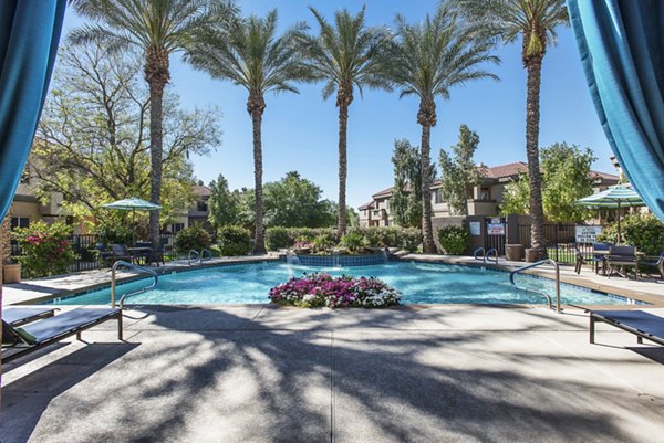 Resort-style pool with lounge chairs at Santa Rosa Apartments, offering a luxurious Greystar living experience