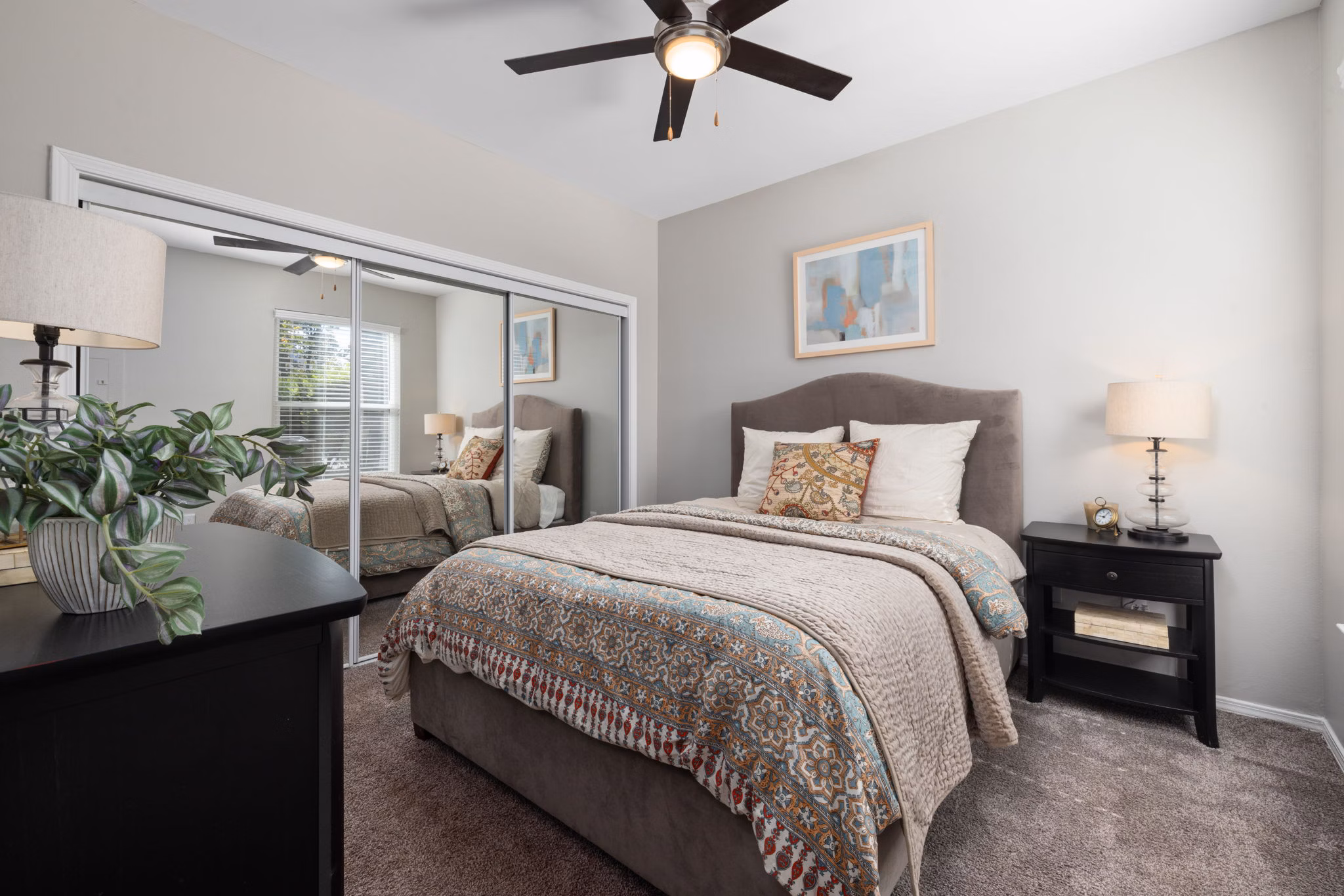 Cozy bedroom with modern furnishings at Cary Greens at Preston Apartments